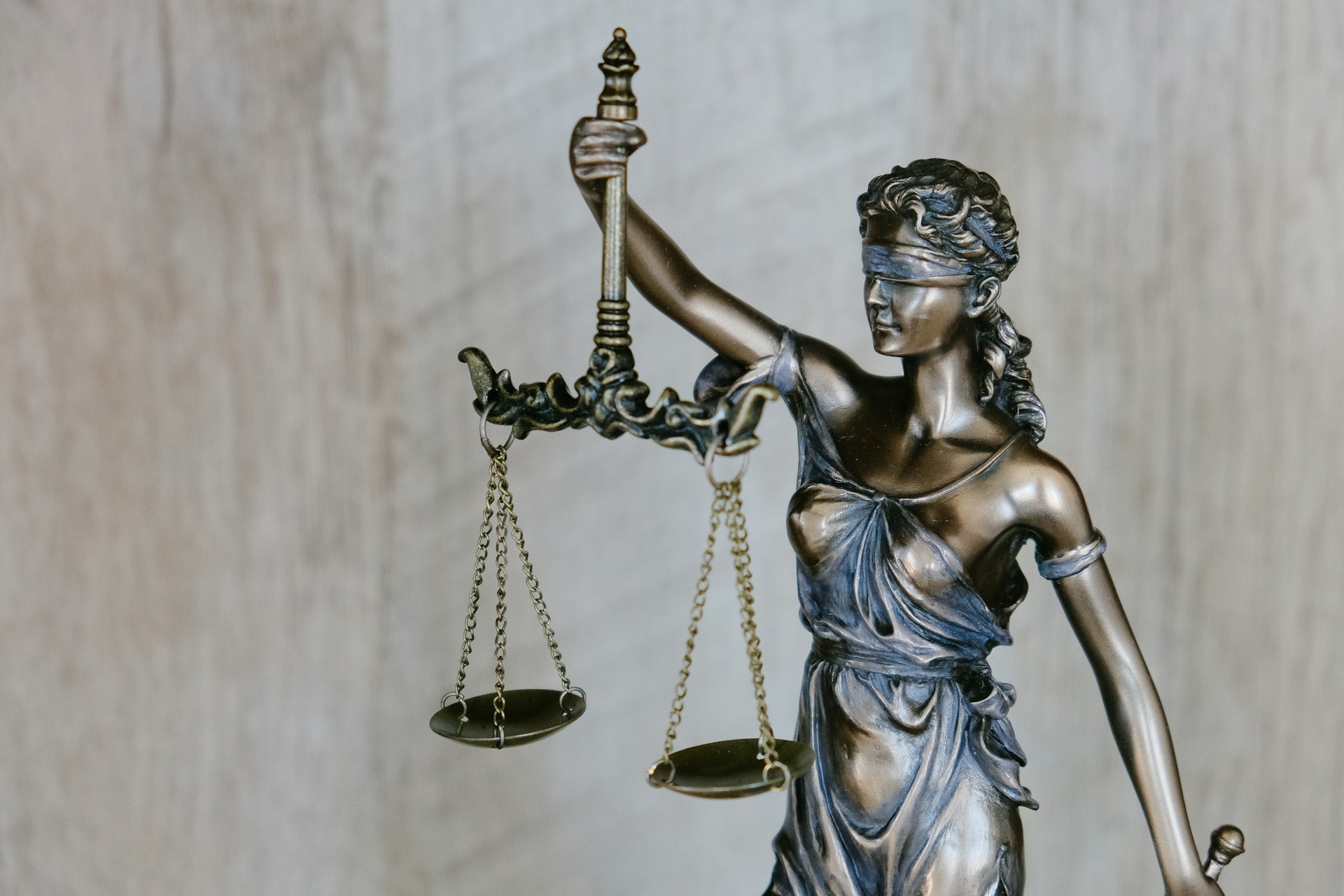 Bronze statue of Lady Justice holding a set of scales